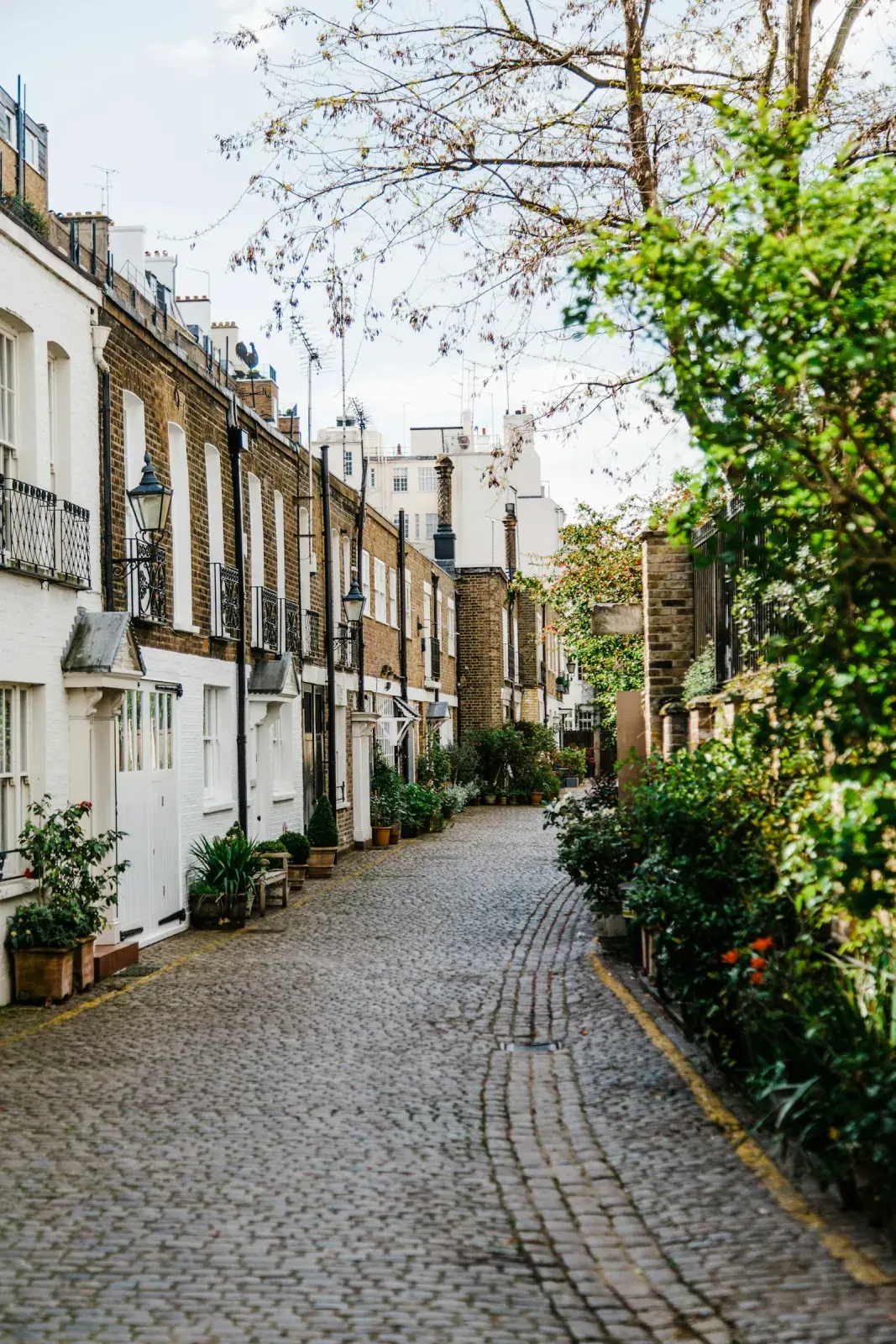 A cobbled London street with brick houses