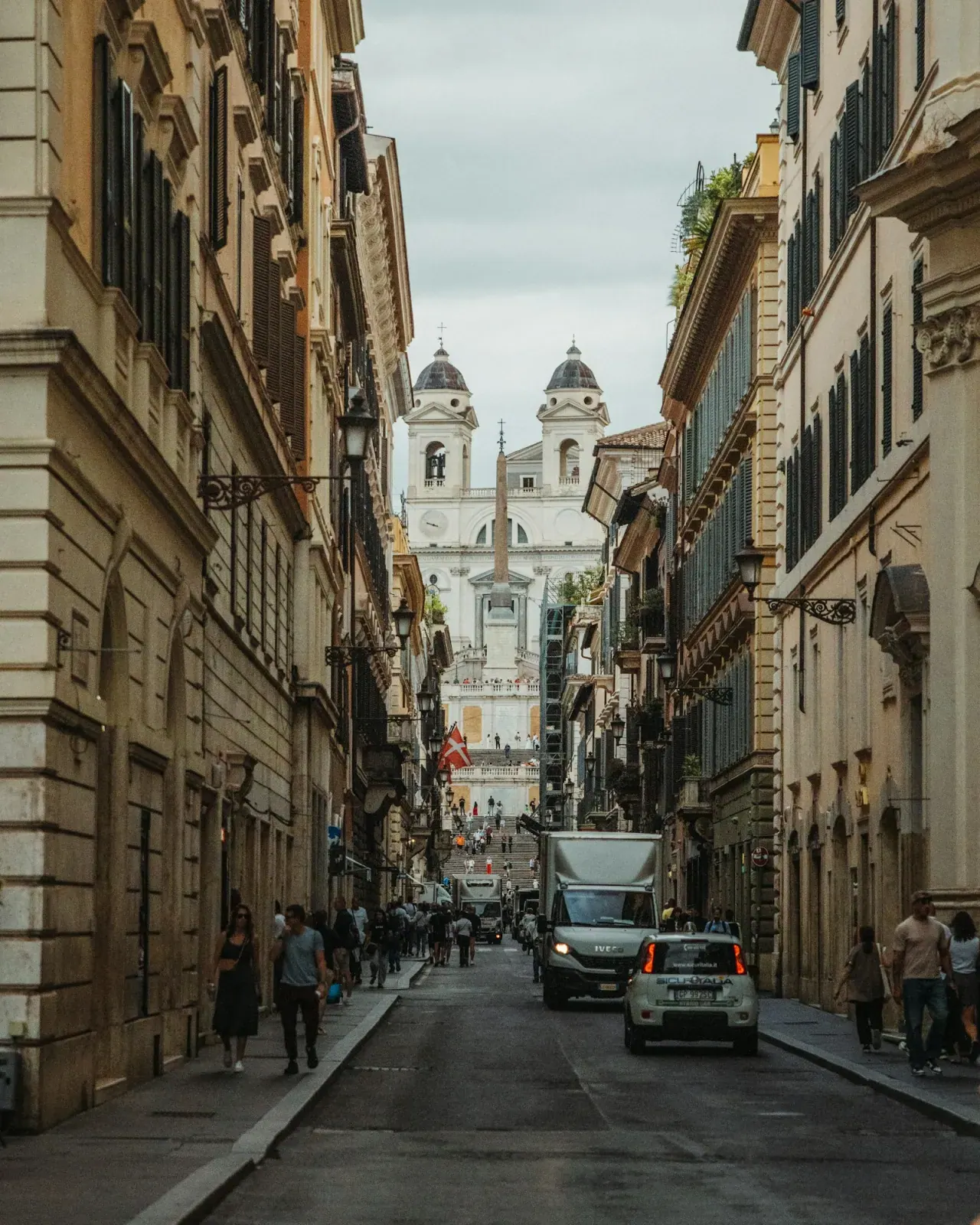 A Rome street with people and old houses